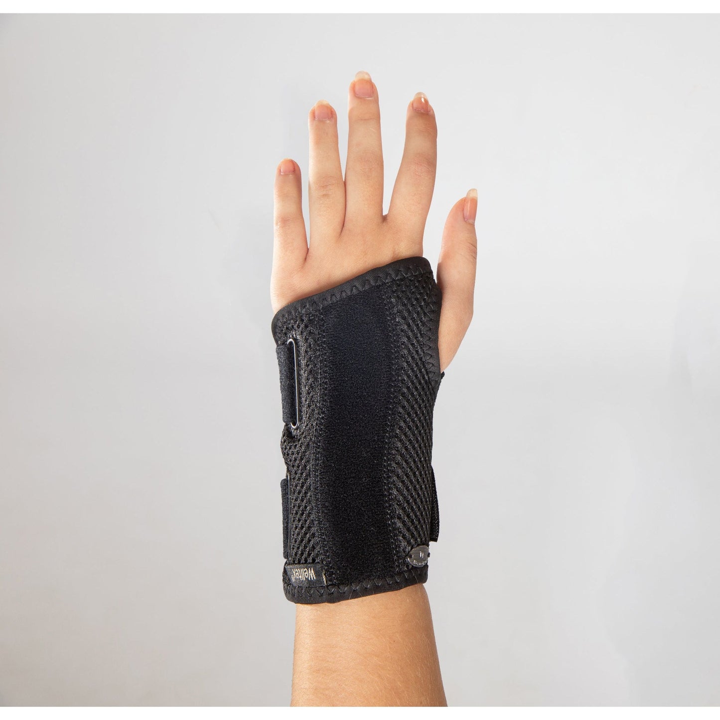 black splinted carpus wrist brace on hand (palm side down)