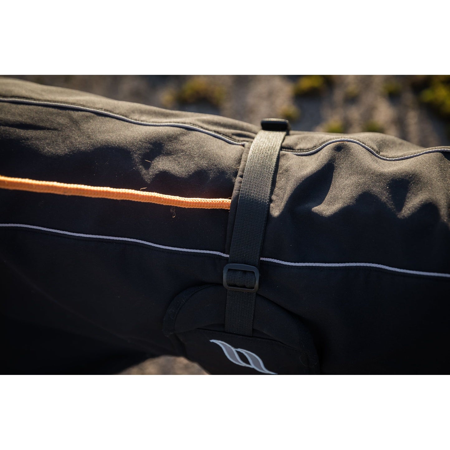 black dog jacket with reflective detail, close up of leash loop hole