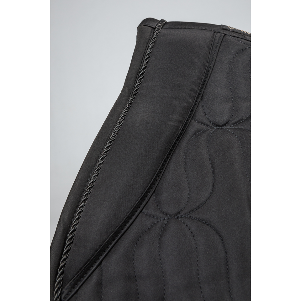 close up details of Elegant all-black jumping saddle pad with padded cushions