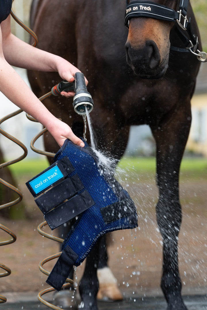 person hosing down a cool on track wrap to activate it