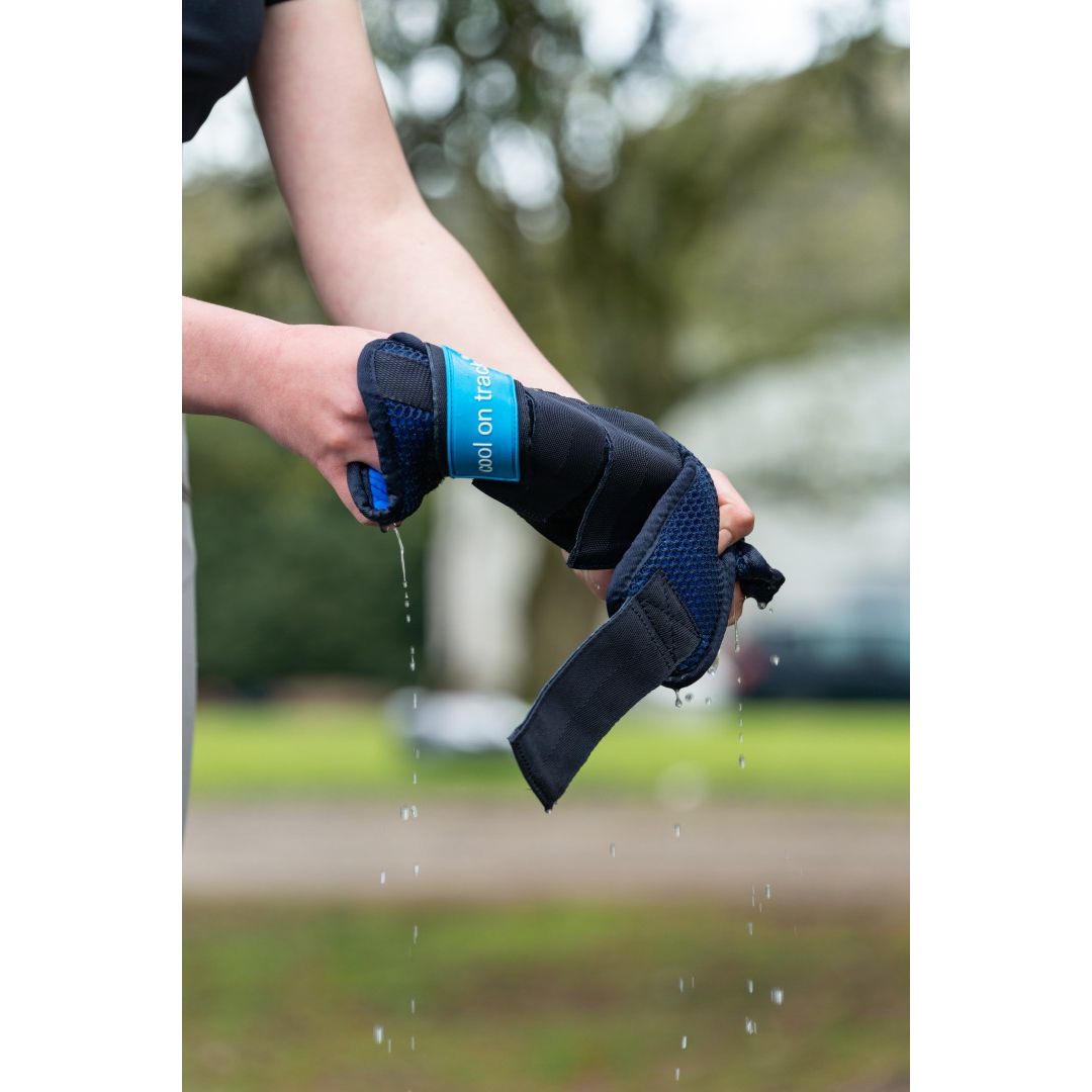 person removing excess water from cool on track wraps