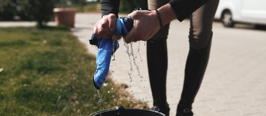person wringing out a wet towel