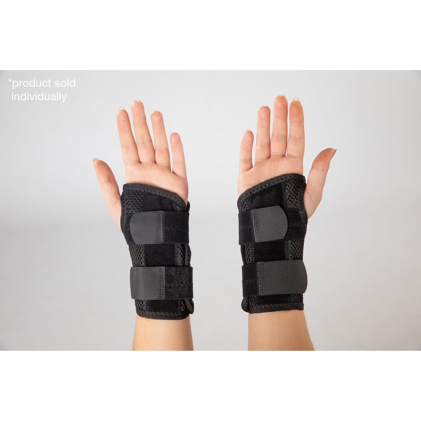 black splinted carpus wrist brace on hand (palm side up)