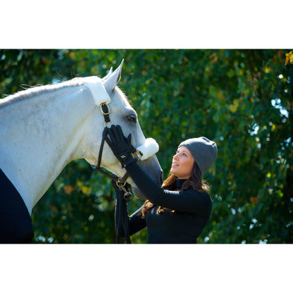 pair of black riding gloves being worn whist stroking a horse