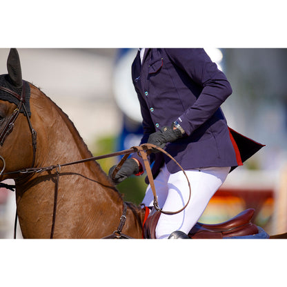 pair of black riding gloves being worn whist riding a horse