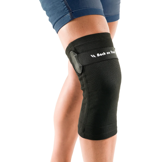 black knee brace with velcro strap being worn by person