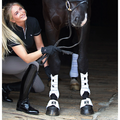 horse wearing white royal work boots on front and hind legs