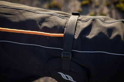 black dog jacket with reflective detail, close up of leash loop hole