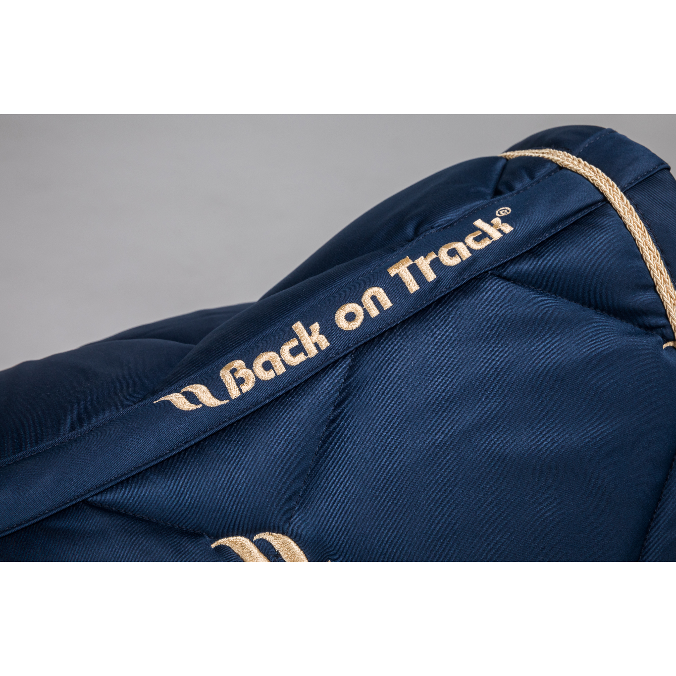 navy saddle pad back on track logo detail in gold