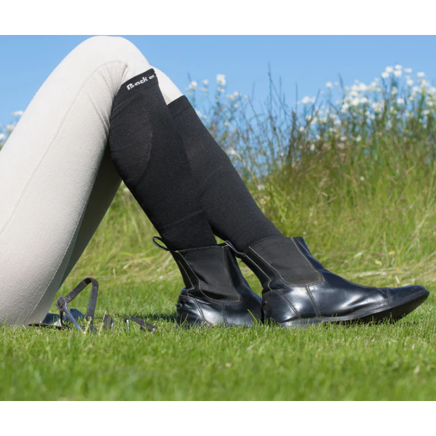 black knee sock with back on track logo at top, being worn by rider