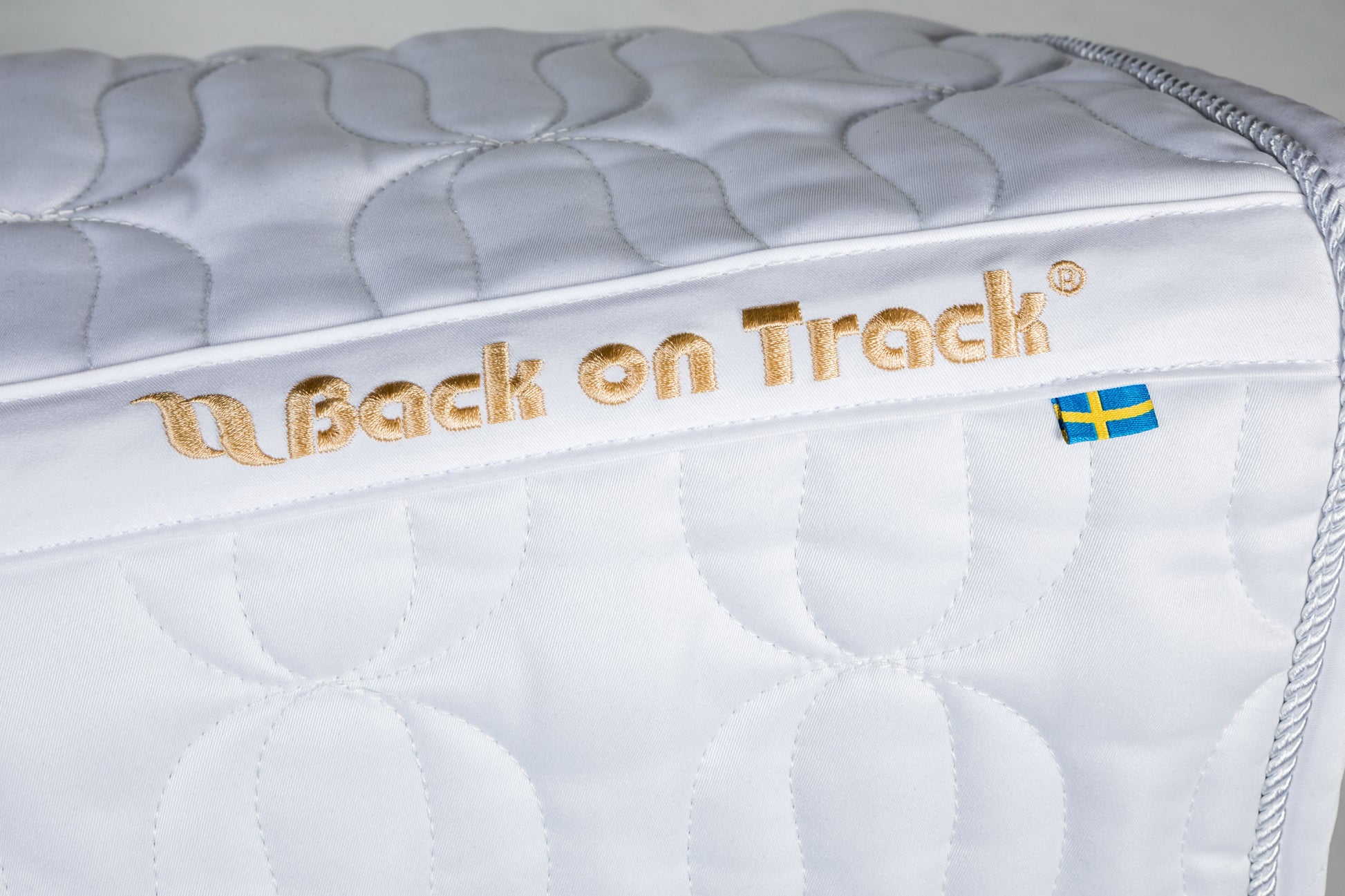 white dressage saddle pad with gold embroidery 