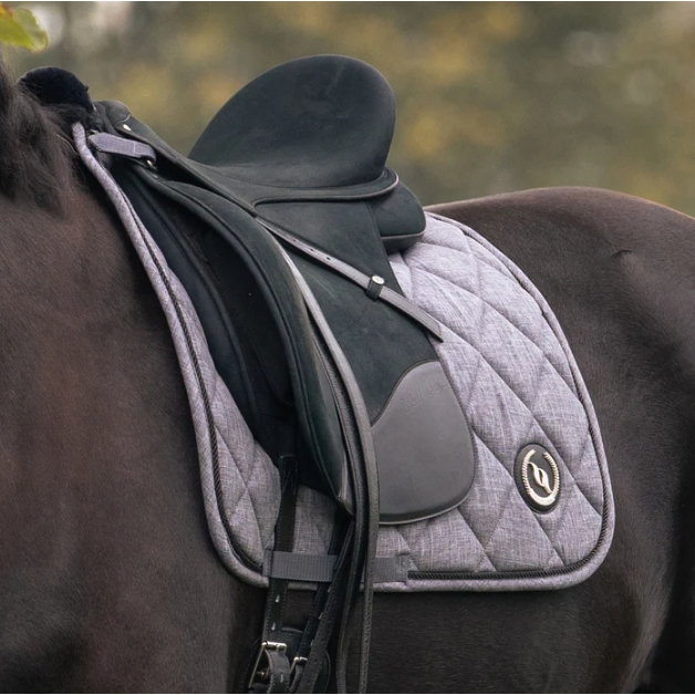 grey quilted dressage saddle pad with logo on horse