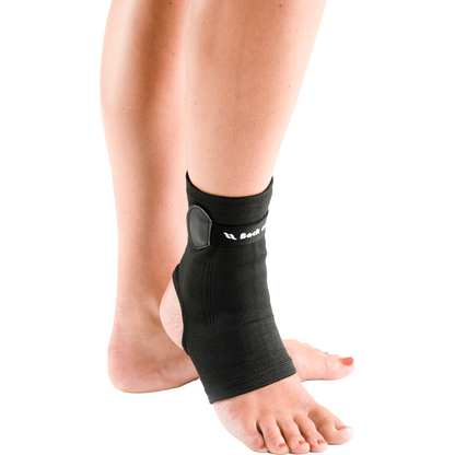 black ankle brace, hole at ball of foor and toes, velcro strap worn by person