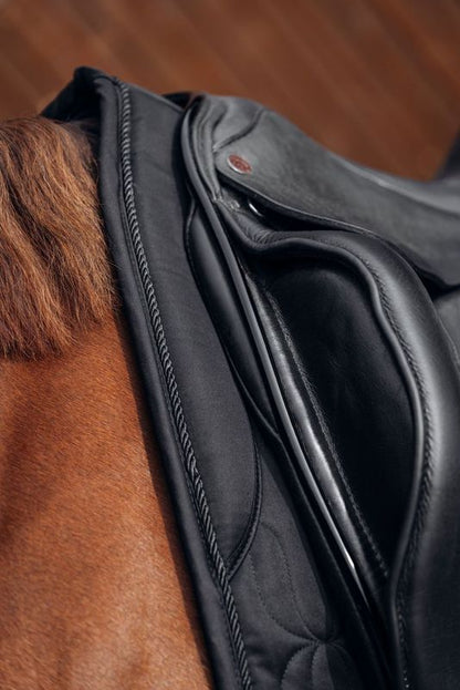 close up detail of padded pad of black dressage saddle pad